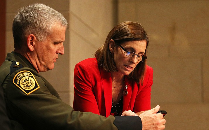 Rep. Martha McSally, R-Tucson, talks with Paul Beeson, director of a joint border task force in Arizona, after a hearing on the fight against drug cartels, which McSally called a “continuous public safety concern.” (Photo by Andres Guerra Luz/Cronkite News)