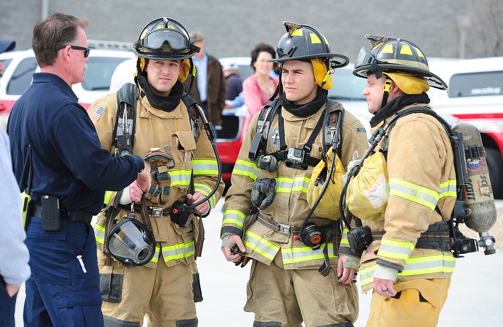 Training captain Joe Kelley goes over final instructions with Caden Burch, Jace Hall and Russell Smith as new Central Arizona Fire & Medical Authority firefighters do their final academy drill in front of friends and family Wednesday, February 22 in Prescott Valley. (Les Stukenberg/The Daily Courier)