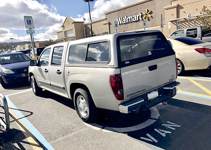 A vehicle at a Prescott-area Walmart store is parked in one of the wider spaces reserved for handicapped customers. A new bill would allow only those needing wheelchair access to park in the wider spaces.