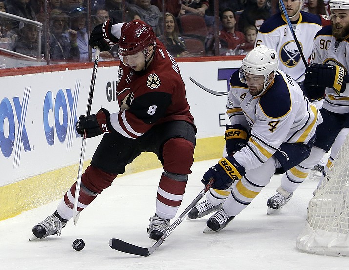 Arizona Coyotes right wing Tobias Rieder (8) shields the puck from Buffalo Sabres defenseman Josh Gorges in the second period during an NHL hockey game, Sunday, Feb. 26, 2017, in Glendale, Ariz.