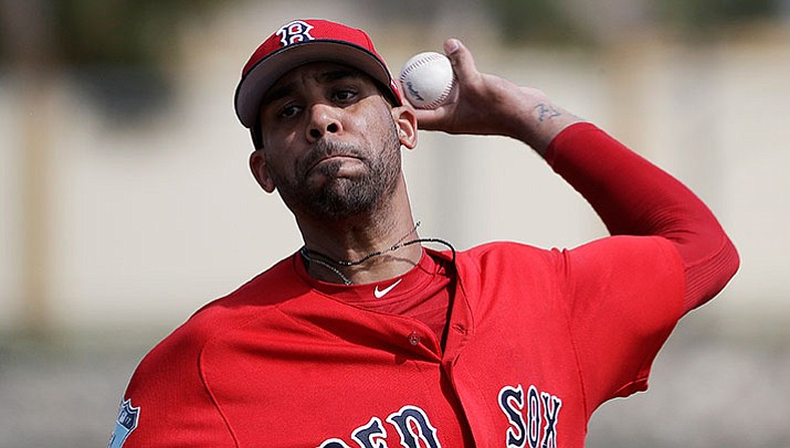 In this Feb. 19, 2017, file photo, Boston Red Sox pitcher David Price throws a live batting session at a spring training baseball workout in Fort Myers, Fla. Red Sox left-hander David Price was scratched from his first spring training start and will consult with specialists after experiencing soreness in his left forearm and elbow.