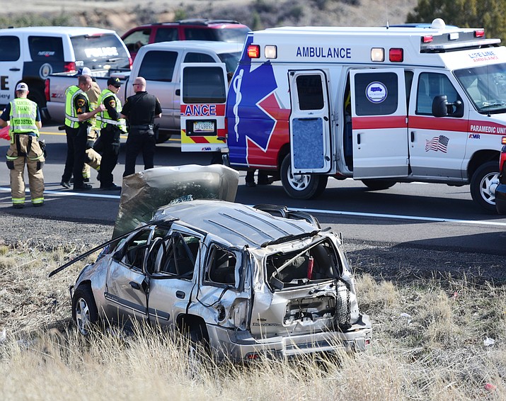 Emergency personnel transport the second of two people from this single vehicle rollover on Highway 69 north of Enterprise Parkway in Prescott Valley Friday, March 10. "Both were level one (most serious) and at least one of the victims was flown from the helicopter pad to a trauma center" Central Arizona Battalion Chief Brad Davis said. (Les Stukenberg/The Daily Courier)