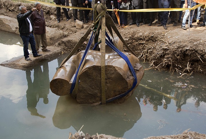 A massive statue, that may be of pharaoh Ramses II, one of the country's most famous ancient rulers, is pulled out of groundwater in a Cairo slum, Egypt, Monday, March 13, 2017.