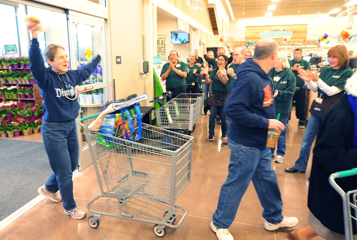 Shopper Terry Green celebrates the grand opening of Sprouts Farmers Market on Wednesday, March 15, in Prescott. More than 200 people lined up for the 7 a.m. opening. The first 200 received 20 percent off their purchases.