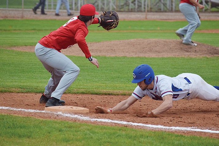 Camp Verde senior utility player Ryan Cain dives back into first base. Cain is hitting .395 and has an .511 on base percentage for the 13-1 Cowboys. (VVN/James Kelley)