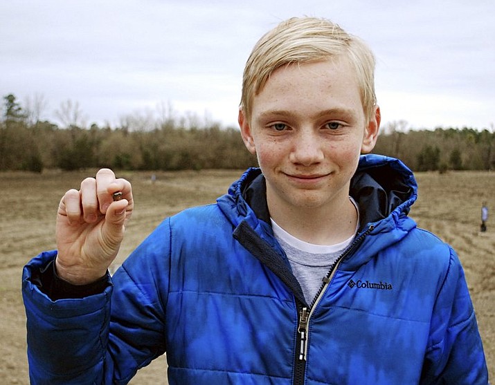 This Saturday, March 11, 2017, photo, provided by the Arkansas Department of Parks & Tourism shows Kalel Langford holding a 7.44 carat diamond he found at Crater of Diamonds State Park in Murfreesboro, Ark.