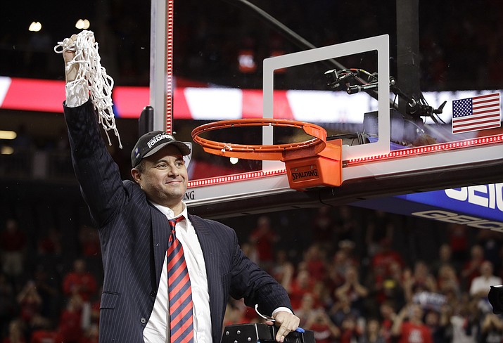 Arizona coach Sean Miller celebrates as he cuts down the net after Arizona defeated Oregon Oregon in an NCAA college basketball game in the championship of the Pac-12 men’s tournament March 11 in Las Vegas. Arizona won 83-80. (John Locher/AP)