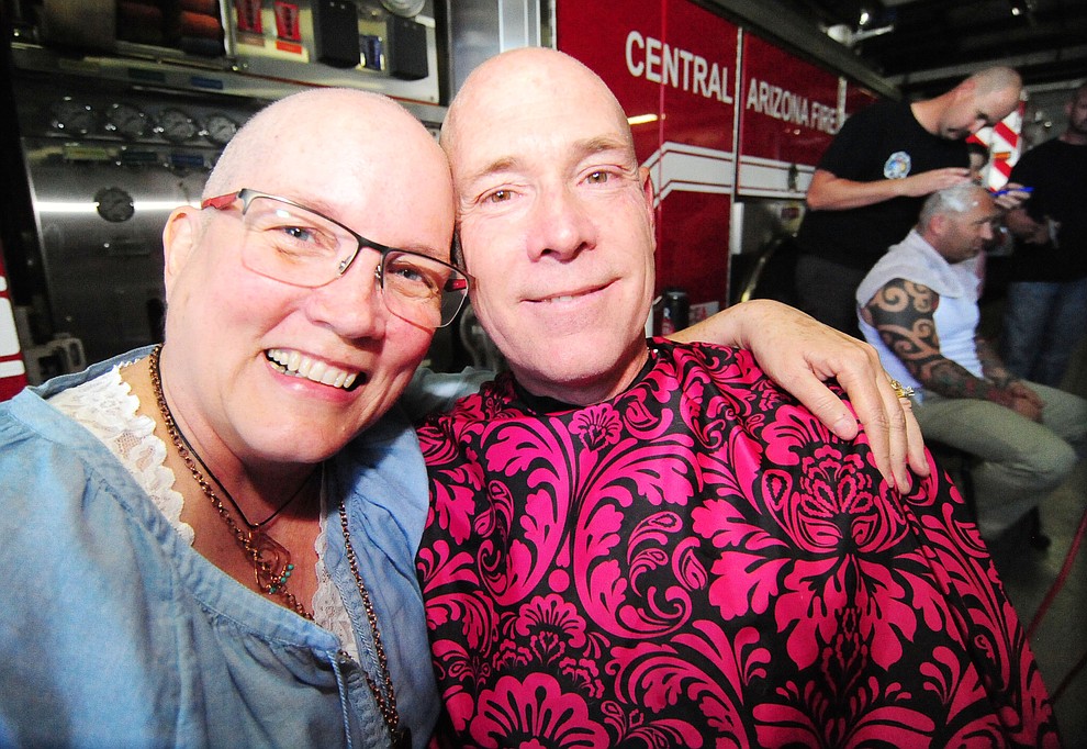 Patty Brookins and Capt. Brian Burch show off their shaved heads as Central Arizona Fire & Medical firefighters shaved their heads to support their Human Resources Manager Brookins Saturday, March 18 in Prescott Valley.