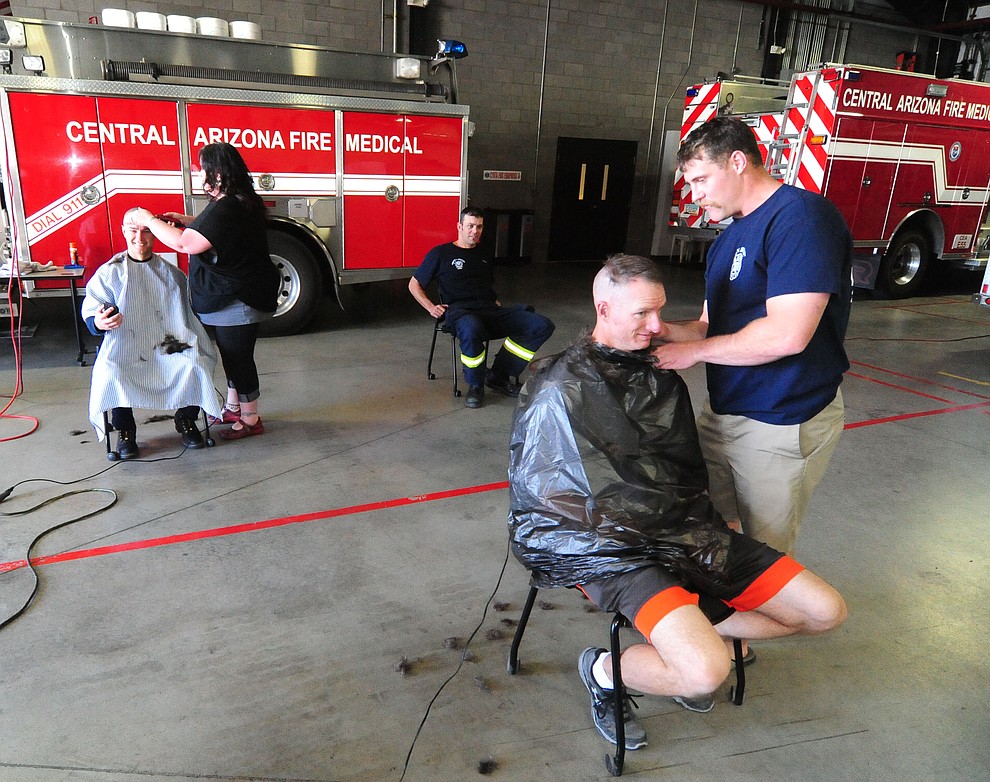 Central Arizona Fire & Medical firefighters shave their heads to support their Human Resources Manager Patty Brookins Saturday, March 18 in Prescott Valley.