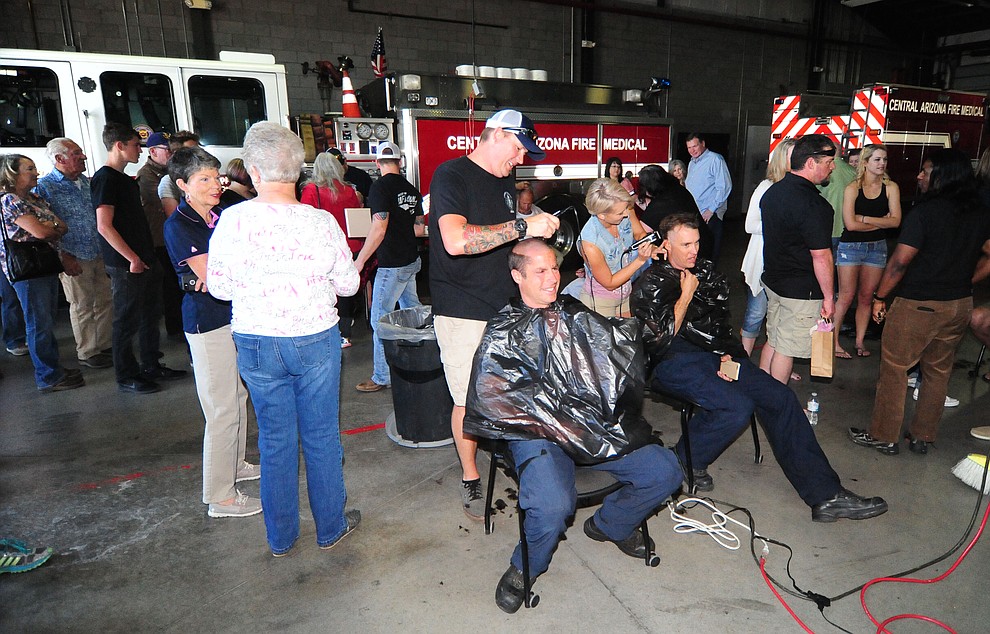 Central Arizona Fire & Medical firefighters shave their heads to support their Human Resources Manager Patty Brookins Saturday, March 18 in Prescott Valley.