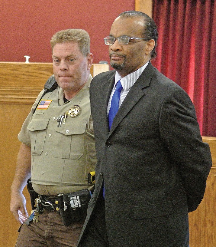Yavapai County Sheriff's Office Detention Officer Shane Chaves escorts Marzet Farris III out of a courtroom in handcuffs after being found guilty for first degree murder and three other counts Thursday, February 12, 2015 at the Yavapai County Courthouse in downtown Prescott. Sentencing for Farris will be on March 16, 2015.