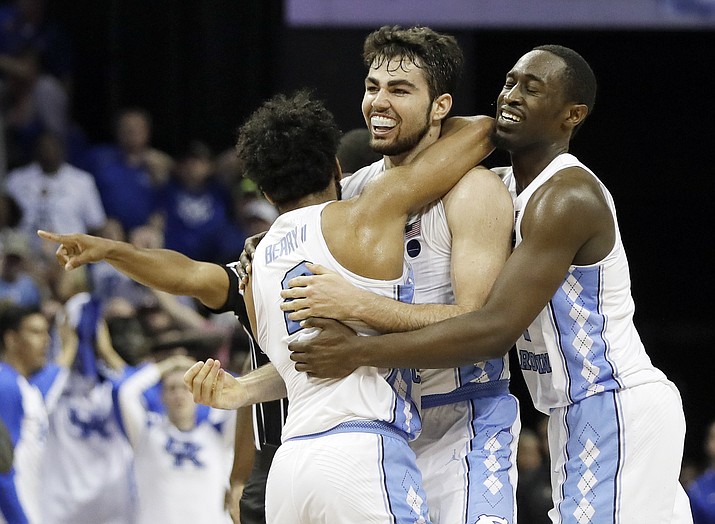North Carolina forward Luke Maye, center, celebrates with teammates after shooting the winning basket in the second half of the South Regional final game against Kentucky in the NCAA college basketball tournament Sunday, March 26, in Memphis, Tenn.