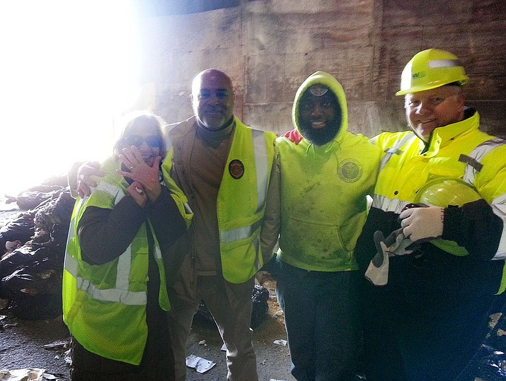 Shannon Lombardo (left) poses with a team of New York City Sanitation Department workers who managed to track down her wedding and engagement rings after she accidentally tossed them into the garbage.