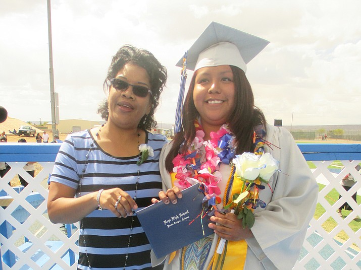Katrice Puhuhefvaya graduated from Hopi High last year. Academic Counselor Dushon Monongye congratulated her. Now, she is excelling at Northern Arizona University.  Photo/Stan Bindell 