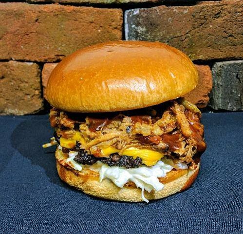 Marino's Mob Burger serves up the Two Knife Burger -- Shredded BBQ Pork on top of 100 percent ground chuck burger with cheddar cheese, coleslaw and Texas toothpicks. 