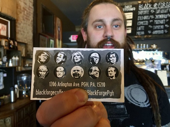 Nick Miller, co-owner of the Black Forge Coffee House in Pittsburgh's Allentown neighborhood, holds a punch card featuring President Donald Trump and nine other conservative politicians and media icons. The card has caused a mini-furor with the shop receiving a deluge of phone calls and online comments, both of disparagement and support from around the country. Miller says the satiric cards are meant to express frustration with the system and nothing more.