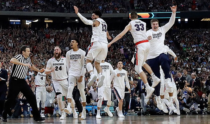 Gonzaga players celebrate after the semifinals of the Final Four NCAA college basketball tournament against South Carolina, Saturday, April 1, in Glendale. Gonzaga won 77-73.