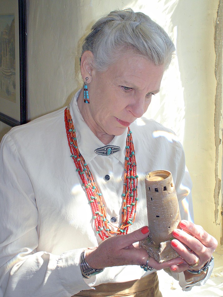 Elizabeth Ware, as Mary Colter, holds up a rendition of Desert View Watchtower.  Photo courtesy Edgeware Productions