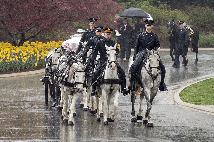A horse drawn caisson carries former astronaut and Sen. John Glenn to his final resting place during the interment ceremony at Arlington National Cemetery on Thursday, April 6, 2017, in Arlington, Va. Glenn was the first American to orbit Earth on Feb. 20, 1962, in a five-hour flight aboard the Friendship 7 spacecraft. In 1998, he broke another record by returning to space at the age of 77 on the Space Shuttle Discovery.