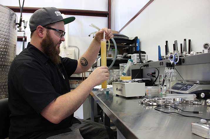 Carlos Bassetti, Superstition’s Head Mead Maker, uses a hydrometer to determine the amount of sugar in the mead.