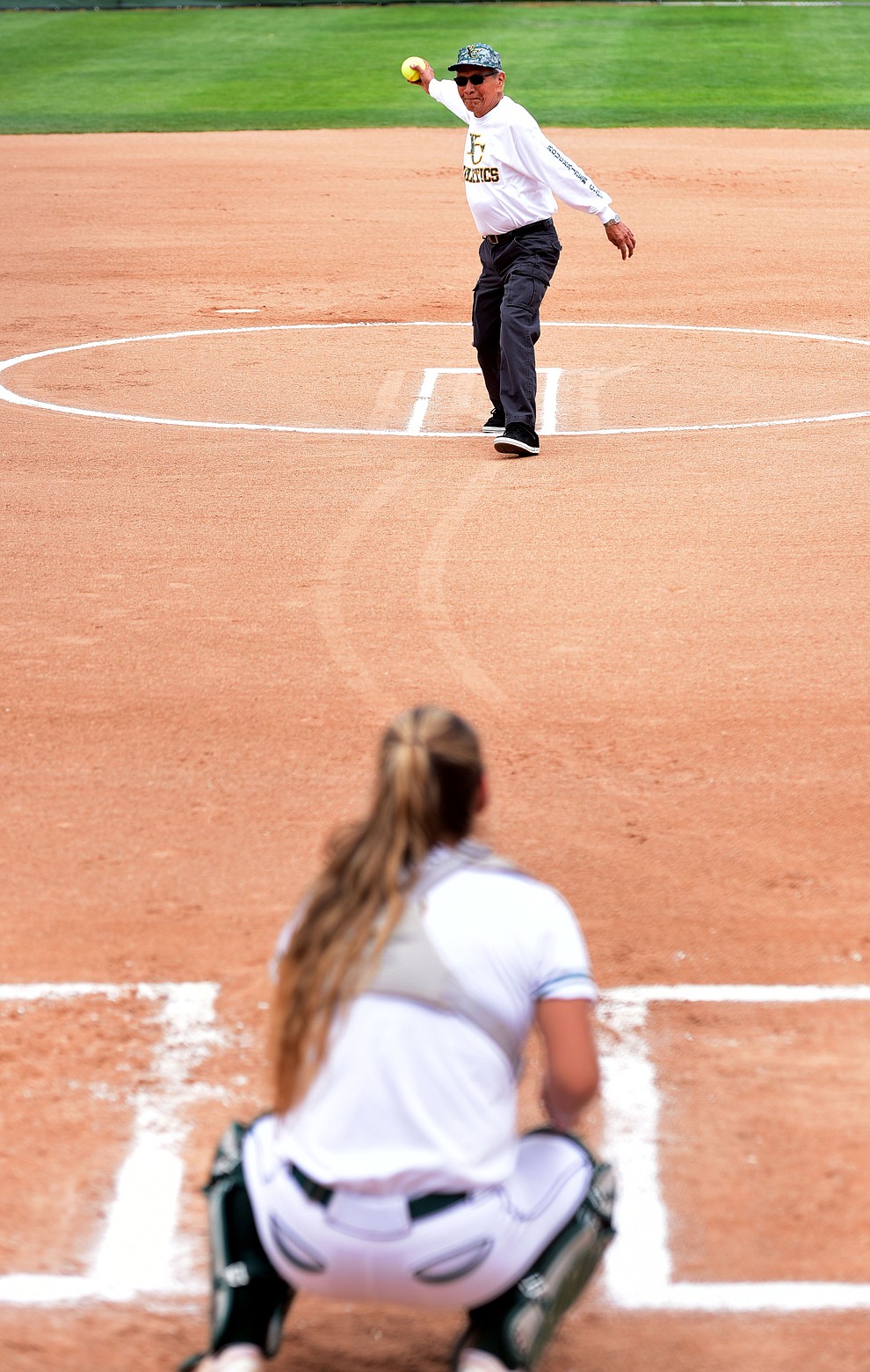 Yavapai/Prescott Indian Tribe President Ernest Jones Sr. throws out the first pitch as the Lady Roughriders play Central Arizona in softball Saturday, April 8 in Prescott.  (Les Stukenberg/Courier)
