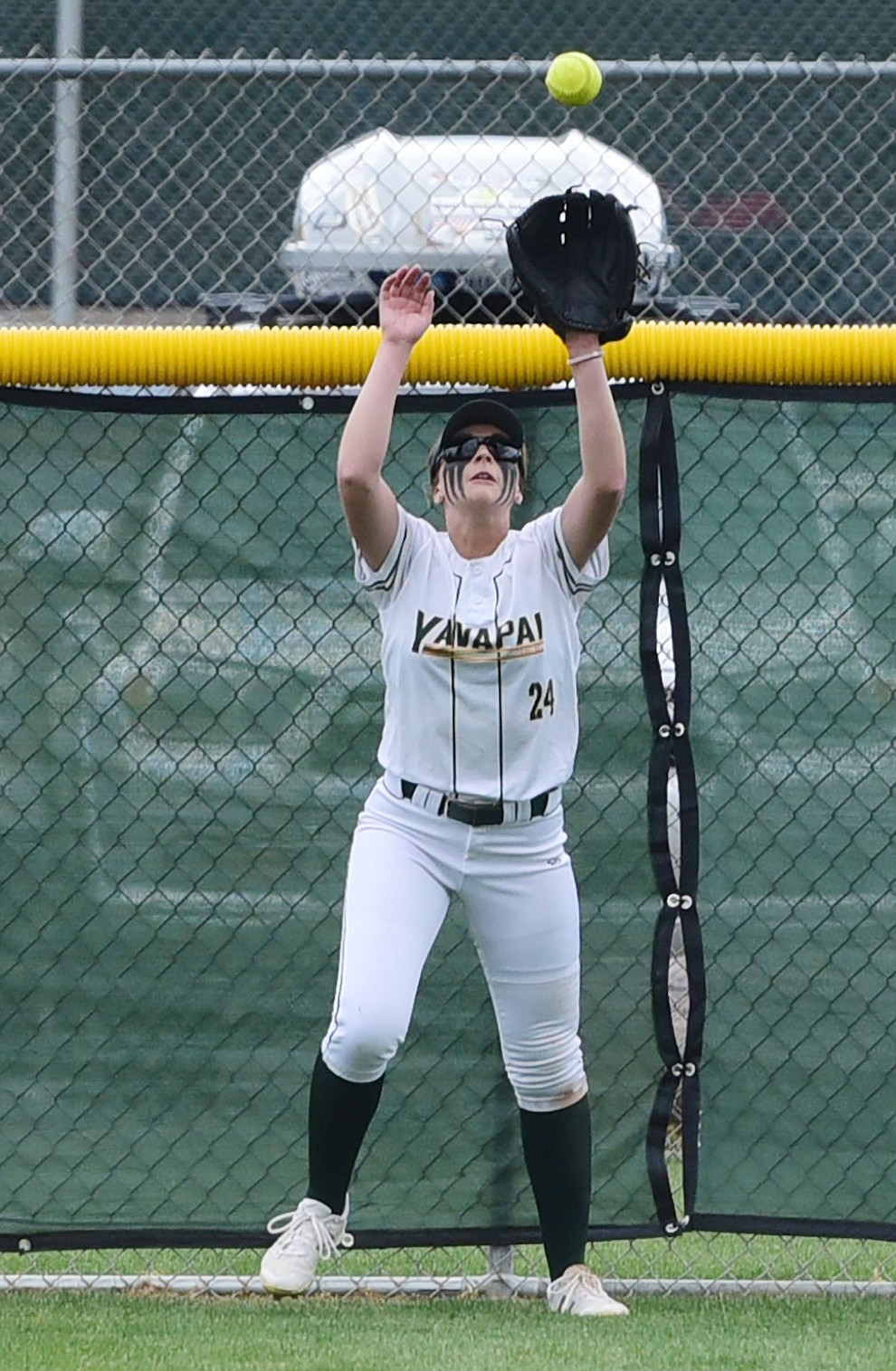 Yavapai's Mikayla Newham makes the catch against the fence as the Lady Roughriders play Central Arizona in softball Saturday, April 8 in Prescott.  (Les Stukenberg/Courier)