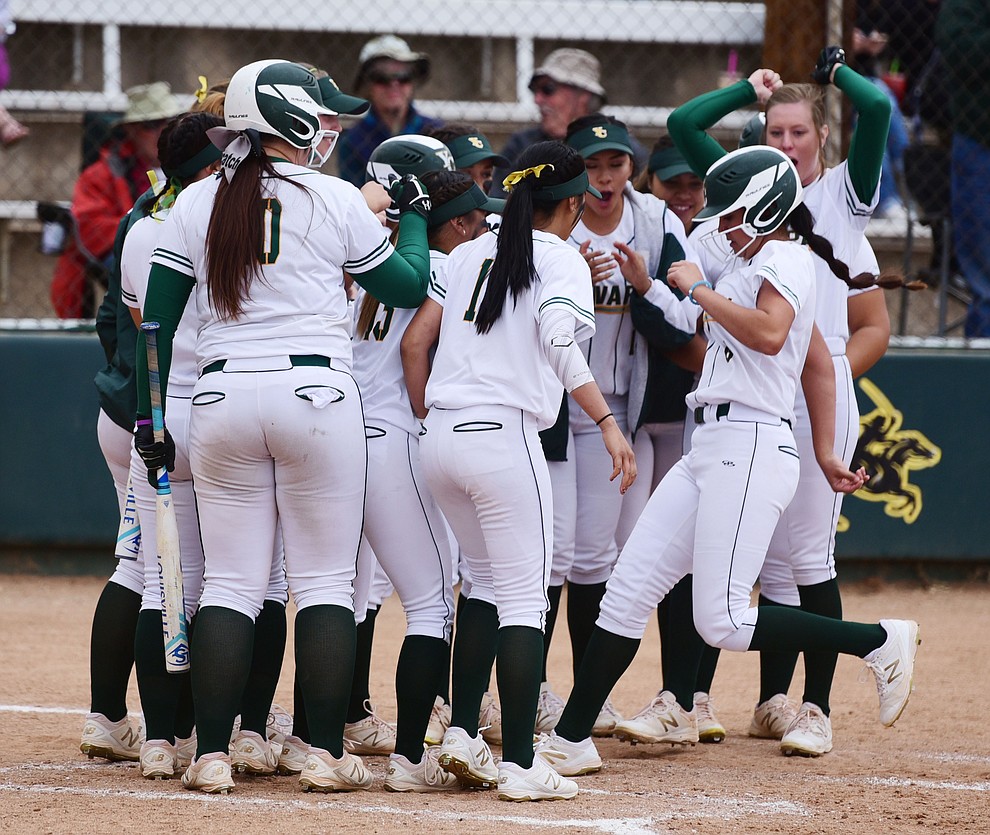 Yavapai's Andrea Sotelo trots home to her teammates after a homerun as the Lady Roughriders play Central Arizona in softball Saturday, April 8 in Prescott.  (Les Stukenberg/Courier)