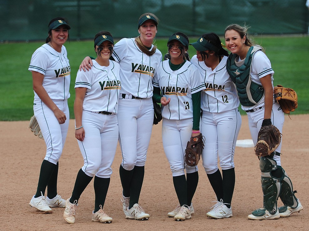 Yavapai infielders keep loose posing for pictures during an official timeout as the Lady Roughriders play Central Arizona in softball Saturday, April 8 in Prescott.  (Les Stukenberg/Courier)