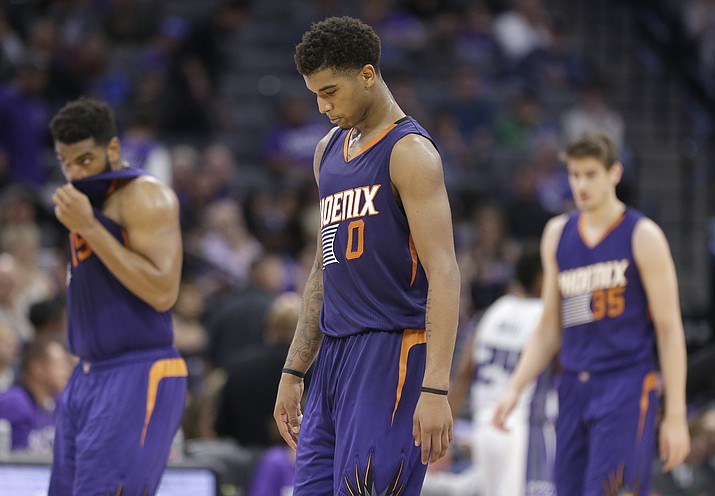 Phoenix Suns forward Marquese Chriss, center, walks off the court during a timeout in the closing moments of the Suns 129-104 loss to the Sacramento Kings during in an NBA basketball game Tuesday, April 11, in Sacramento, Calif. (Rich Pedroncelli/AP)