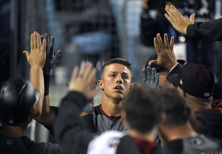 Arizona Diamondbacks’ Jake Lamb is congratulated by teammates after hitting a solo home run during the eighth inning Monday, April 17, in Los Angeles. (Mark J. Terrill/AP)