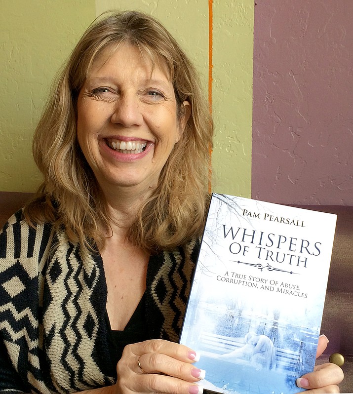 Former County Assessor Pam Pearsall shows off her book, “Whispers of Truth.”