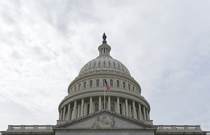 A flag flies on Capitol Hill in Washington. Lawmakers return to Washington this week to a familiar quagmire on health care legislation and a budget deadline dramatized by the prospect of a protracted battle between President Donald Trump and congressional Democrats over his border wall.