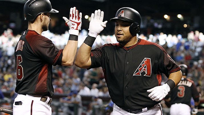 Arizona Diamondbacks' Yasmany Tomas, right, is congratulated by teammate Chris Owings after his solo home run against the Los Angeles Dodgers during the first inning of a baseball game, Saturday, April 22, in Phoenix. 