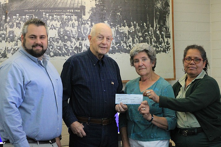 Al Richmond (center), a member of the Grand Canyon Historical Association, presents a $1,500 check to the Williams Library Historic Photo Preservation Project April 13. From left: City Manager Skylor Miller, librarian Andrea Dunn and Kaibab National Forest historian Margaret Hangan accept the check from Richmond.