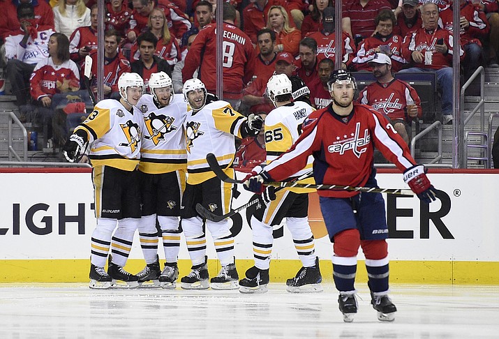 Pittsburgh center Matt Cullen (7) celebrates his goal with Olli Maatta (3), of Finland, Tom Kuhnhackl (34), of Germany, and Ron Hainsey (65) as Washington Capitals defenseman Kevin Shattenkirk (22) skates away during the second period of Game 2 in an NHL hockey Stanley Cup second-round playoff series, Saturday, April 29, in Washington.