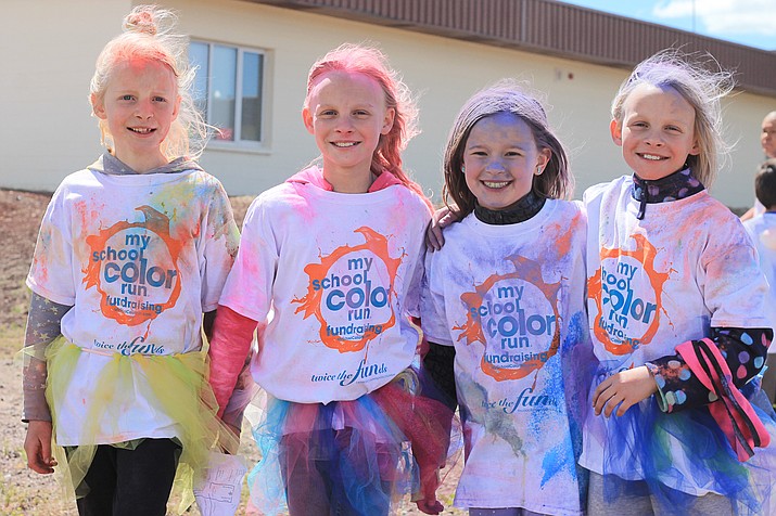 Giuliana Fairlie, Gretchyn Fairlie, Addyson Endicott, and Geneva Fairlie celebrate after completing the run. 