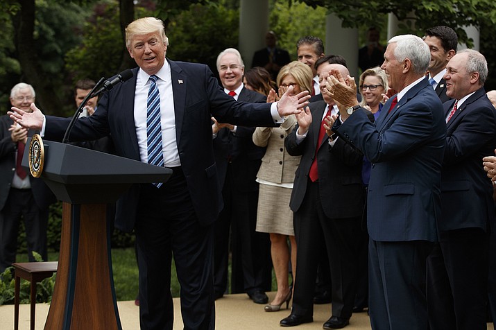 President Donald Trump, accompanied by GOP House members, speaks in the Rose Garden of the White House in Washington, Thursday, May 4, 2017, after the House pushed through a health care bill. (AP Photo/Evan Vucci)