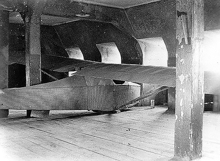 Stolen bed slats and floor boards from the prison were used to construct the ribs and frame of the plane. Electrical wiring from unused portions of the castle were fitted as rudder and elevator control wires. The skin of the glider was made from sleeping bags sealed with boiled ration millet. (This is the only known photograph of the original glider taken on 15 April 1945 by Lee Carson, one of two American newspaper correspondents.)