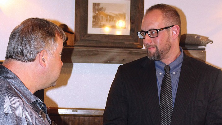 Councilman Travis Lingenfelter, right, speaks with a constituent at Monday’s Conservative Republican Club meeting.