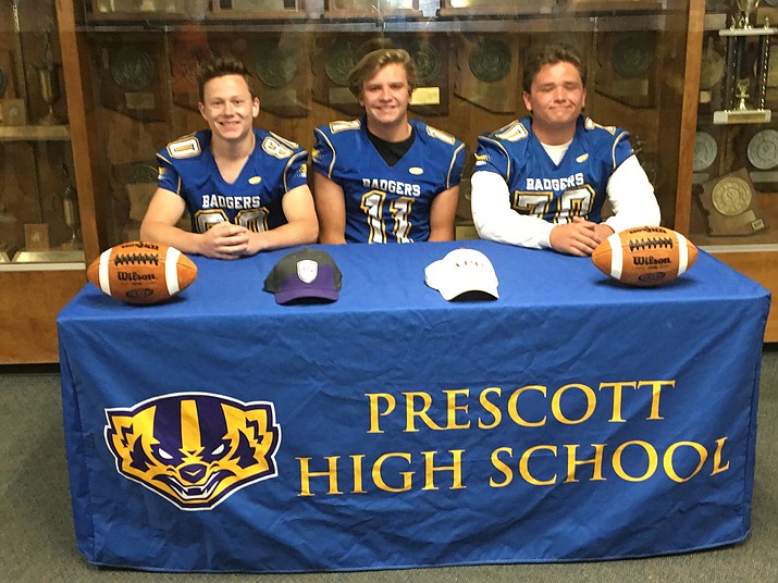 From left to right: Corey Huard, Aaron Marquardt and Zach Sweeney smile after signing a letter of intent to play college football Monday in Prescott. (Badger Athletics/Courtesy)