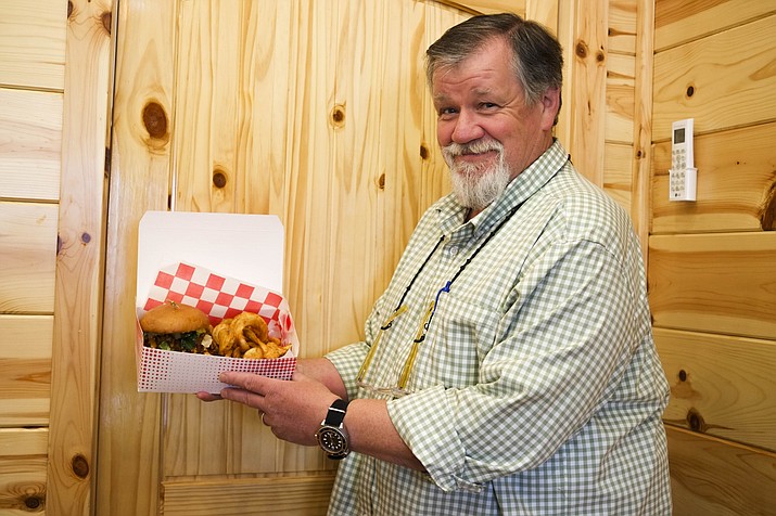 Leighton Wildrick, owner of Cowgirl Coffee Cake Company displays a fried chicken sandwich. 