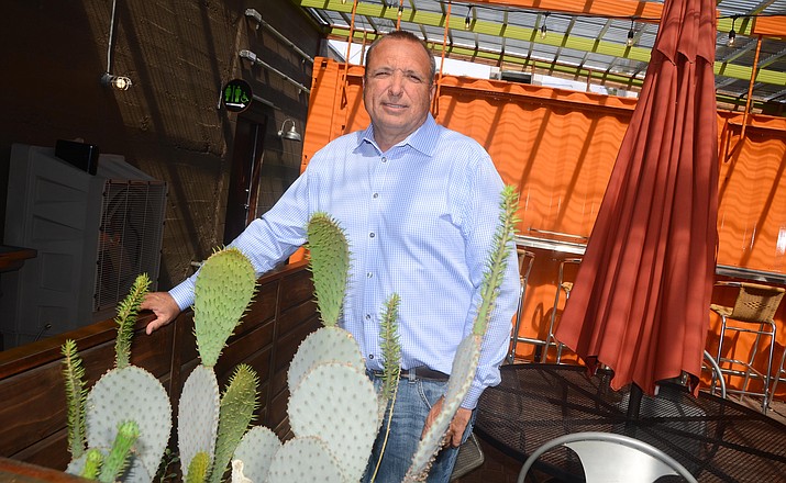 Eric Jurisin opened his first restaurant in Old Town Cottonwood 14 years ago and he hasn’t stopped since. Even today, construction workers will be completing the second-floor expansion of his Tavern Hotel. (Photo by Vyto Starinskas)