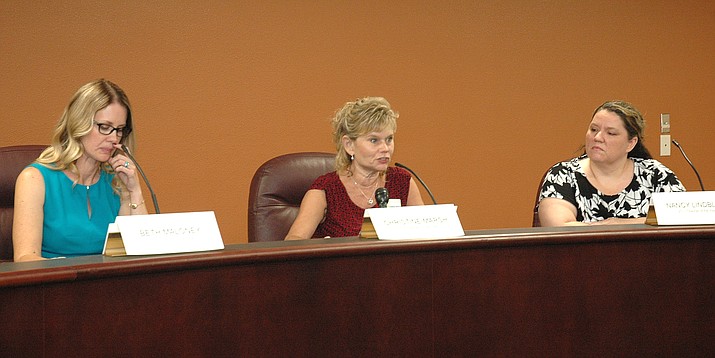 Christine Marsh, center, details her views of the just-completed legislative session Monday, as Beth Maloney, left and Nancy Lindblom, former teachers of the year like Marsh, listen during a forum. (Capitol Media Services photo by Howard Fischer)