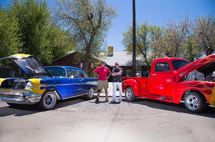 American Legion Cordova Post No. 13 members John Holst and Rodger Ely stand in front of the Legion Post between two classic cars. 