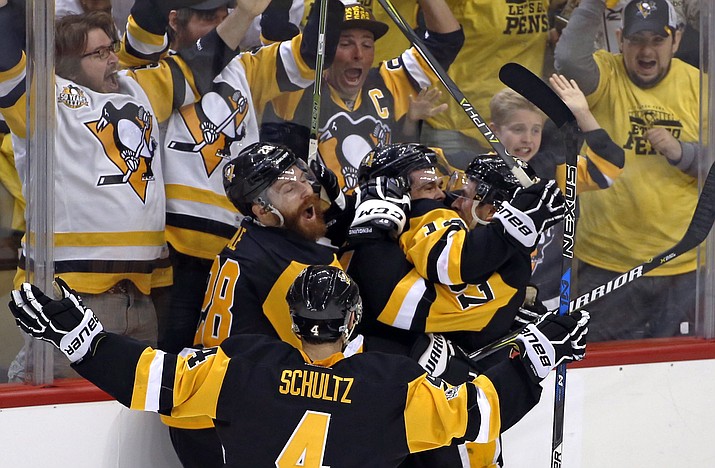 Pittsburgh Penguins’ Chris Kunitz, center, celebrates his game winning goal with Ian Cole, left, Sidney Crosby, right, and Justin Schultz (4) in the second overtime period of Game 7 of the Eastern Conference final in the NHL Stanley Cup playoffs in Pittsburgh, Friday, May 26, 2017. The Penguins won in double overtime 3-2 to advance to the Stanley Cup Finals. (Gene J. Puskar/AP)