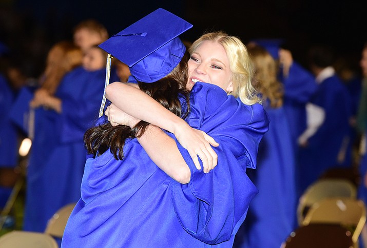 Loving hugs after the 345 members of the Prescott High School Class of 2017 held their Commencement on Bill Shepherd Field Friday, May 26. (Les Stukenberg/Courier)