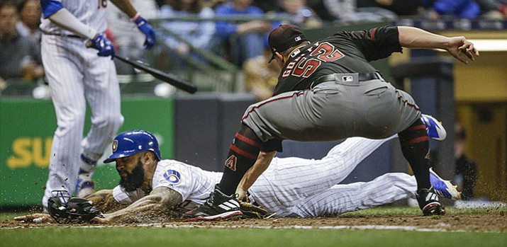 Milwaukee Brewers' Eric Thames is tagged out at home by Arizona Diamondbacks' Zack Godley on a runner's fielder's choice during the sixth inning Friday night, May 26, in Milwaukee.