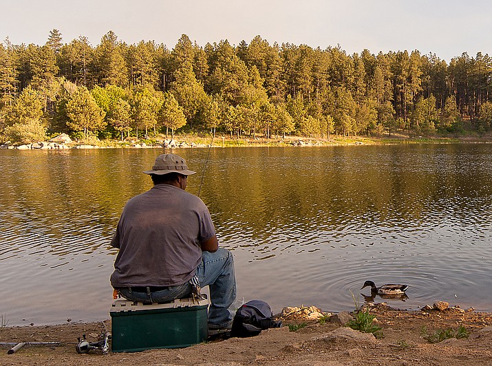 Luis Mendoza waits for a bite while fishing at Goldwater Lake on June 18, 2015, in Prescott. Goldwater Lake will host a Free Fishing Day on Saturday, June 3. (Matt Hinshaw/Courier, File)