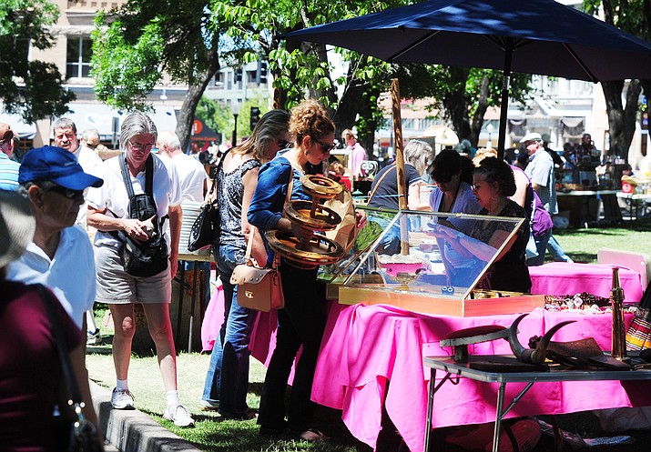 Shoppers look through some of the antiques that about 40 vendors brought to the Yavapai County Courthouse Plaza in 2015. The 2017 event is set for Sunday, June 4.