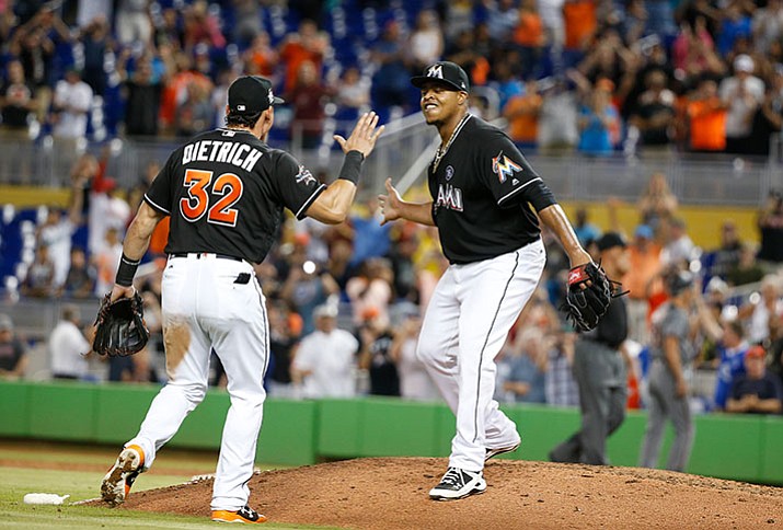 Miami pitcher Edinson Volquez, right, celebrates with Derek Dietrich (32) after throwing a no-hitter against the Diamondbacks on Saturday, June 3, in Miami. (Wilfredo Lee/AP)